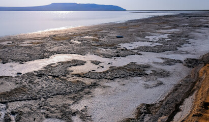 Drying salt lake in the Crimea, self-sedimentary salt on the silty shore of the lake