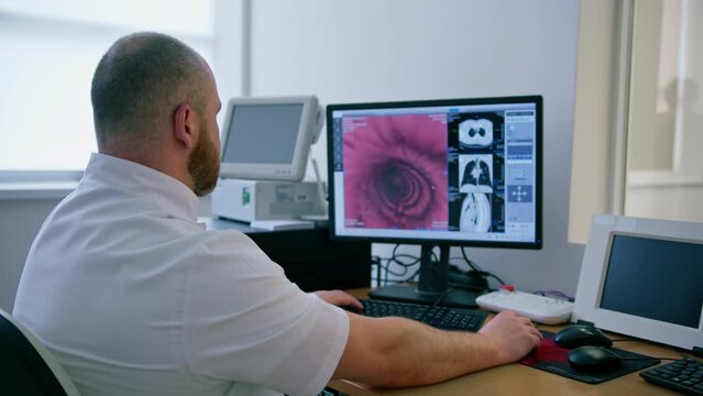 the patient undergoes computer tomography in the clinic, the radiologist monitors the progress of the procedure and the results of the stomach scan