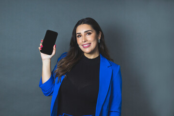 beautiful latin young woman smiling, showing cell phone screen. businesswoman