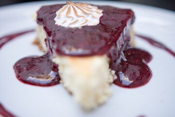Shot of Peruvian Tres Leches Dessert dish Cake with strawberry sauce