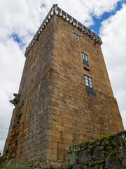Medieval stone tower with windows, in the village of Vilanova dos Infantes in Galicia, Spain, summer of 2021