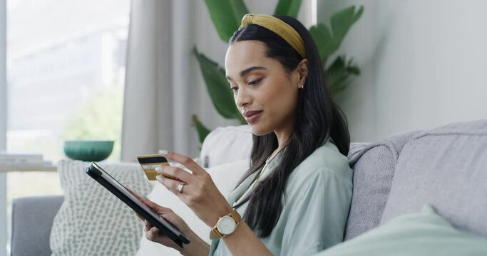 Woman, tablet and credit card on sofa for online shopping, payment or financial banking at home. Female shopper in purchase or transaction on technology or bank app for ecommerce on living room couch