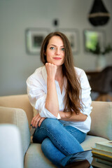 Portrait of an attractive young woman relaxing in her modern home