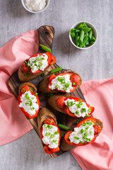 Bruschetta on rye bread with ricotta, pepper, tomato and green onion top and vertical view