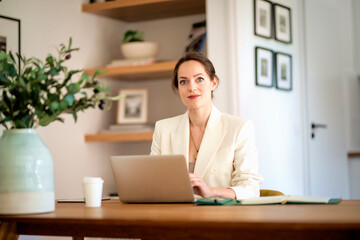 Young businesswoman using laptop and working from home