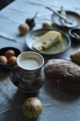 vintage set of ceramics with farm healthy food. Cheese, milk, bread, eggs, kinfolk lifestyle High quality photo