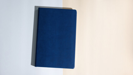 Mockup of dark blue business notepad in leather cover without logo. A5 diary