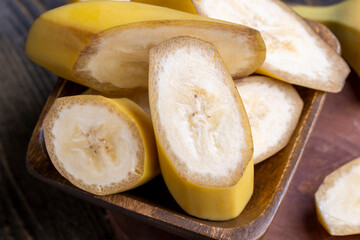 Naklejka na ściany i meble Sliced ripe yellow banana, close up