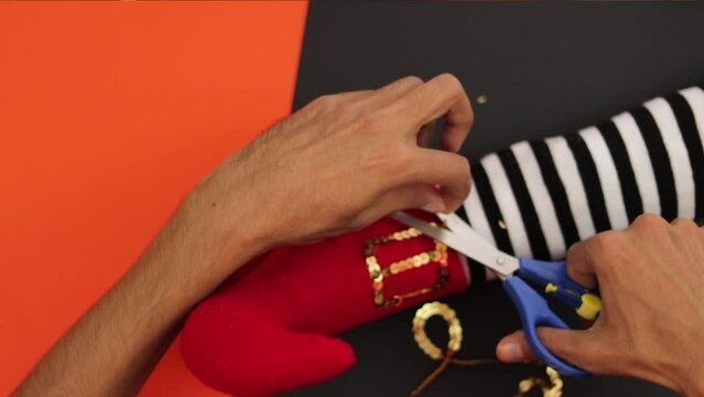 Making scary crafts for halloween day. Witch feet. Treat or trick. Arts and decoration.