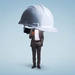 Safety helmet protecting a businessman using a smartphone