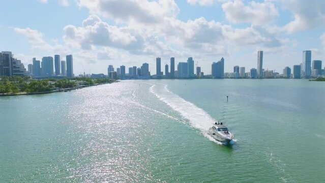 Aerial view of luxury speedboat sailing fast on water with amazing view on Downtown of Miami on background. Florida, Venetian Way