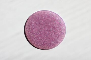 Bright and original pink background with red sequins, in the form of a circle