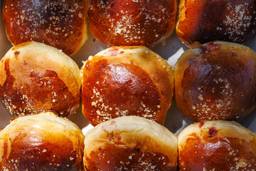 Sweet yeast buns stuffed with rose jam, close up view. Delicious homemade pastries