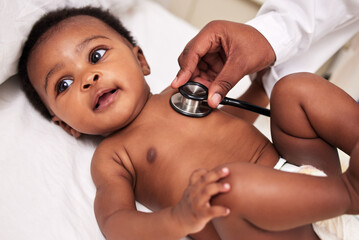 African, little baby and stethoscope in bed for health checkup or pediatrician with infant or...