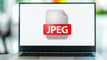 Laptop computer displaying the icon of JPEG file - Powered by Adobe