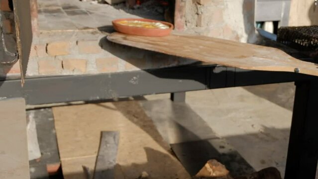 egg and cheese cooked in a clay pot in a traditional wood fire oven. It is taken out from oven by the cheff and shown to the camera