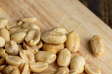 Roasted peanuts on a wooden cutting board