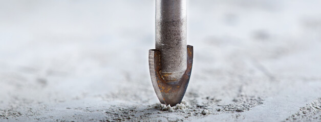 metal drill bit make holes in concrete wall with industrial drill. Building work industry.