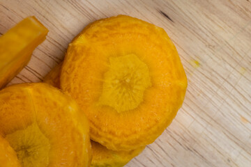 Sliced bright yellow carrots on the table