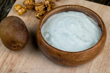 fresh yogurt with kiwi flavor and with pieces of fruit and popcorn