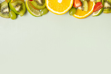 Citrus fruits and strawberries flat lay, top view. Summer layout on colored background