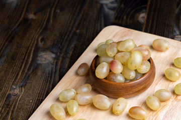 Homemade green unwashed grapes on a board