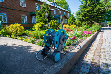 Watering garden hose wound on a reel. A compact, easy-to-use hose for quick garden watering