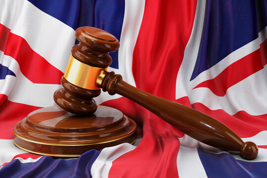 British law and justice concept. Wooden gavel on flag of the Great Britain, 3D rendering