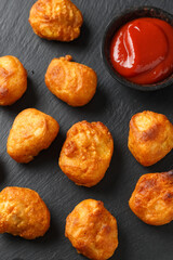 Battered chicken balls with tomato ketchup, party finger food concept