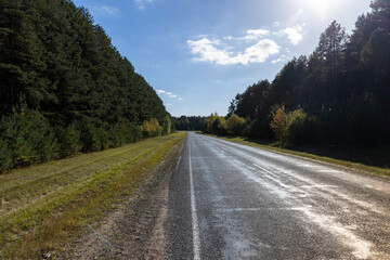 Paved road in the autumn season in sunny weather