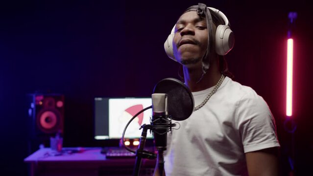 African American hip-hop rapper shows professional skills in music studio