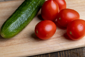 Ripe red fresh tomatoes on a board