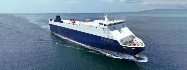 Aerial drone ultra wide photo of Neptune lines RoRo (Roll on-off) car transportation vessel reaching car terminal of Drapetsona