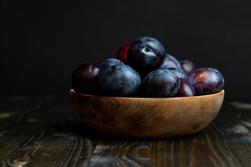 Ripe plums on the table in the kitchen