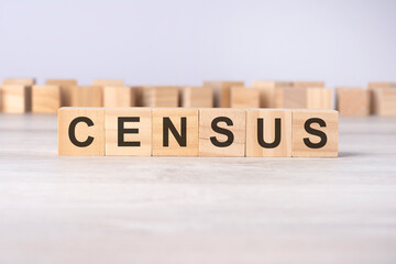 Fototapeta premium word CENSUS inscribed on wooden cubes lying on a light table. economy and investments concept.