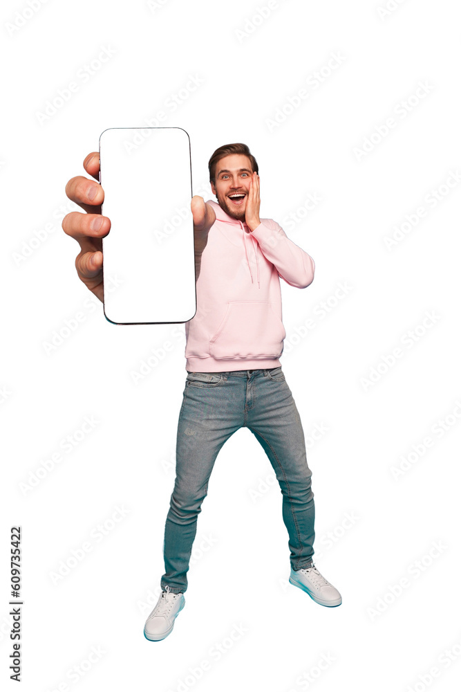 Wall mural mobile app advertisement. handsome excited man showing pointing at empty smartphone screen posing ov