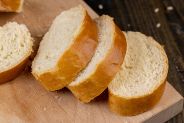 Wheat baguette on a wooden cutting board