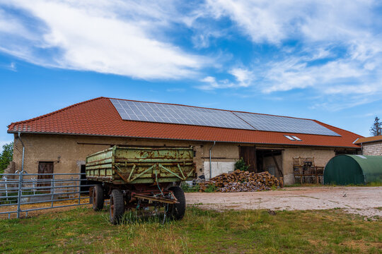 A photovoltaic system on the roof of a large barn