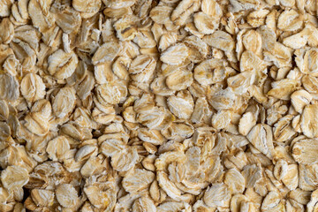 Poured a large amount of oat flakes close-up