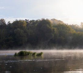 Small fog on the river in autumn