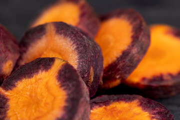 Sliced purple-orange carrots on the table