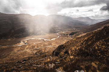 River flowing through the Scottish highlands on a foggy day