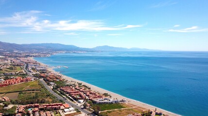 aerial view overlooking Manilva coast holiday homes and beach on the Costa del Sol as well as...