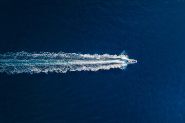 Vacation and leisure. Aerial view on fast boat on blue Mediterranean sea at sunny day. Fast ship on the sea surface. Seascape from the drone. Seascape from air. TSeascape with motorboat. - Powered by Adobe