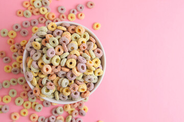 Multicolored corn rings for breakfast on a colored background