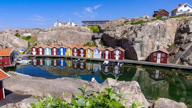 Zoom in time lapse of Idyllic colorful fisherman cabins Smogenbryggan in Smogen, Sweden. Typical Swedish wooden house constructions. 