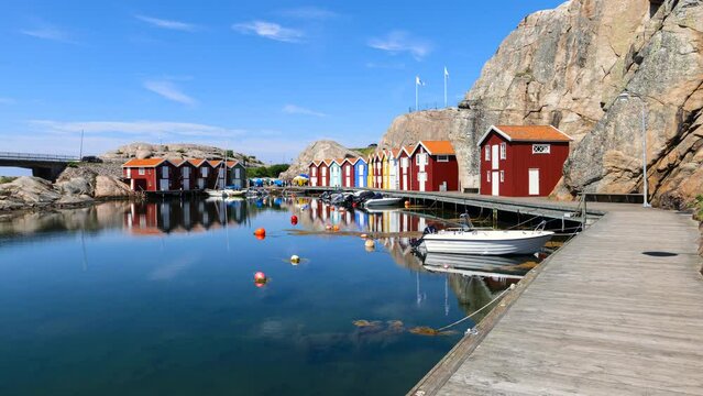 Zoom out time lapse of Idyllic colorful fisherman cabins Smogenbryggan in Smogen, Sweden. Typical Swedish wooden house constructions. 