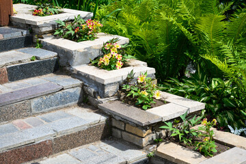 Landscaping on house stairway with flowerbeds, home landscape design.