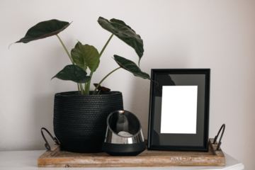 Blank picture frame mockup on white wall / White living room design / View of modern minimalistic style interior with horizontal artwork mock up on wall / Home staging and minimalism concept