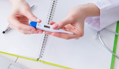 Doctor hand holding temperature thermometer